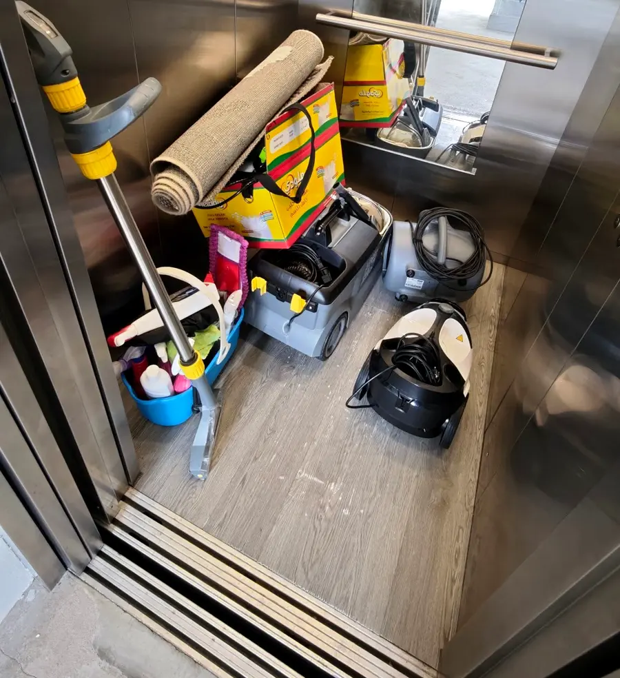 Kärcher spray extractor, steam cleaner, air mover, mop and cleaning products loaded in a lift for a job