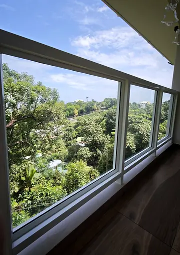 Clean glass windows overlooking a green hillside